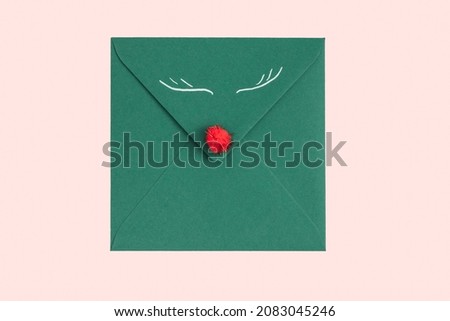 Green envelope with white sheet and Christmas branch isolated on white background. Christmas mail. Concept of congratulation for Christmas or New Year. Top view. Flat lay. Copy space Royalty-Free Stock Photo #2083045246