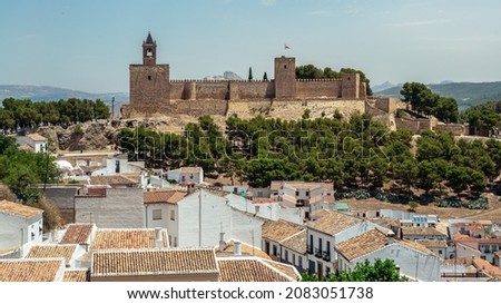 View of the Alcazaba of Antequera is a Moorish fortress in Spain. Castle medieval in Malaga. Arab fortress architecture building among the hills in Andalusia.