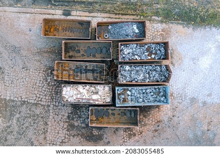 Many containers for collecting scrap metal, collecting metal for secondary raw materials. Metal waste for recycling. Ferrous scrap, non-ferrous scrap. Import and export of scrap. View from above Royalty-Free Stock Photo #2083055485