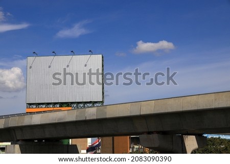 Blank advertising display device over the sky train track, billboard blank for outdoor advertising poster background with beautiful blue sky