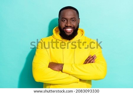 Photo of brunette cool millennial beard guy crossed arms wear yellow sports cloth isolated on teal color background
