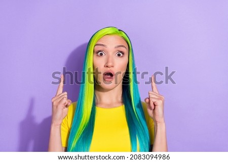 Portrait of young gorgeous lady amazed emotion advertising promote product offer isolated on violet color background