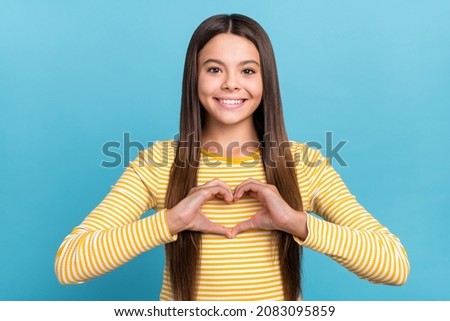 Photo of young pretty girl show fingers heart shape feelings cupid isolated over blue color background