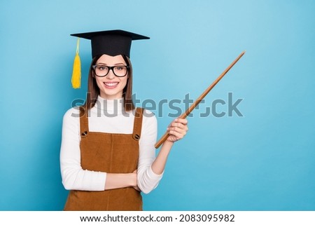 Photo of young cheerful lady master pointer empty space teacher courses isolated over blue color background