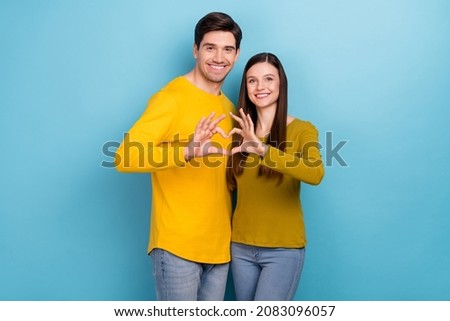 Photo of affectionate couple embrace make heart symbol wear yellow casual outfit isolated blue color background Royalty-Free Stock Photo #2083096057