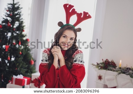 Photo of cheerful young positive woman hold hands together wear deer horns smile indoors inside house home