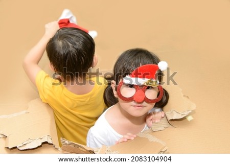 Little girl wearing funny Christmas glasses, having fun while celebrating Christmas day at home