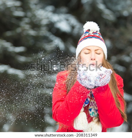 Girl playing with snow in park