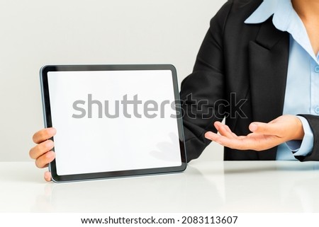 Close up of business woman showing blank tablet screen. Royalty-Free Stock Photo #2083113607