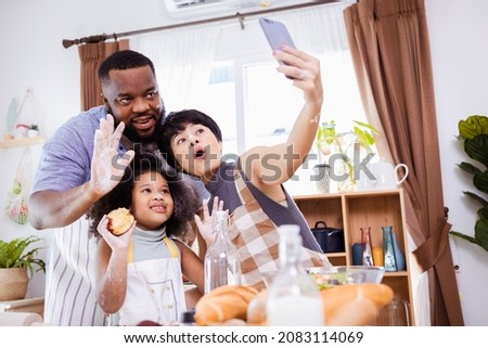 Happy African American family selfie together while preparing the flour for making cookies at home.