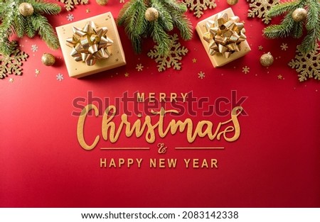 Christmas and new year background concept. Top view of Christmas decoration made from gift box, snowflake, christmas ball and  pine branches on red background.