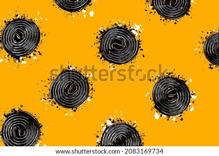 Full frame seamless pattern of sweet spiral liquorice candies on bright yellow background
