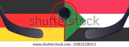 Top view hockey puck with Germany vs. Sudan command with the sticks on the flag. Concept hockey competitions