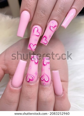 Cute pink acrylic nails with heart design, hand drawing nail art
