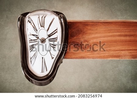 Melting clock on vintage background