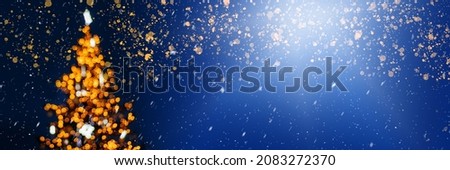 Defocused Christmas tree with lights on dark blue background, banner size