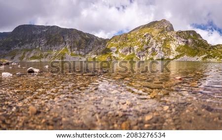 Beautiful landscape of the Seven Rila Lakes,Bulgaria. Amazing nature shot, mountains and lake.Reflecting water on sunny cloudy day. High quality photo