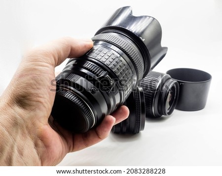 old photo lens in the hand of a man on a white background