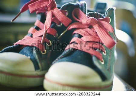 Old children's sport shoes with blurred background