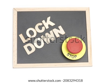 small black chalkboard with wooden letters lock down an emergency stop button on white background as a concept for ending a lockdown