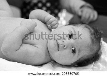 Infant baby during body development examination.