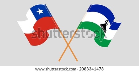 Crossed and waving flags of Chile and Kingdom of Lesotho. Vector illustration
