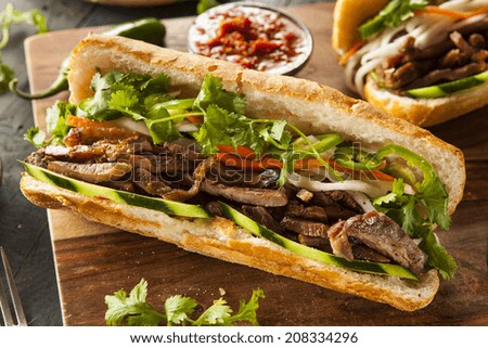 Vietnamese Pork Banh Mi Sandwich with Cilantro and Daikon Royalty-Free Stock Photo #208334296