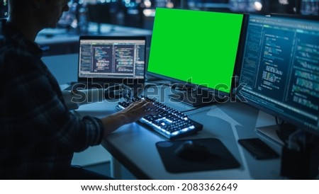 Night Office: Person with Disability Using Prosthetic Arm to Work on Green Screen Chroma Key Computer. Swift and Natural Use of Myoelectric Bionic Hand To Type Code for Software at Night.