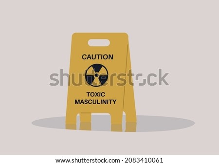 A yellow floor sign warning about toxic masculinity, the idea of manliness as being defined by domination, homophobia, and aggression Royalty-Free Stock Photo #2083410061