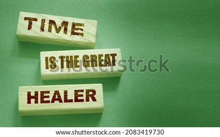 Time is the best healer words on wooden blocks. End of relationship and soul pain concept
