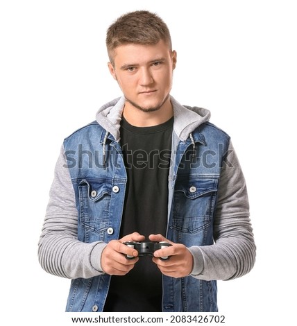Young man with game pad on white background