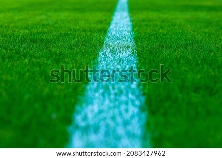 Football field with artificial green grass. Amateur football field. Sunny summer day.