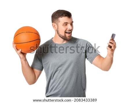 Young man with mobile phone and ball on white background. Concept of sports bet