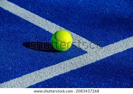 Ball next to the lines on a paddle tennis court. Racket sport concept. Royalty-Free Stock Photo #2083437268