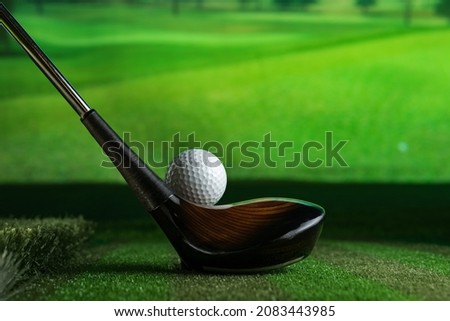 Sreen golf. Putter and golf ball on the background of the screen. Royalty-Free Stock Photo #2083443985