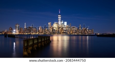 The skyscrapers of the Financial District in Lower Manhattan of New York City at Dusk. Reflection upon Hudson River of World Trade Center buildings, NYC, USA