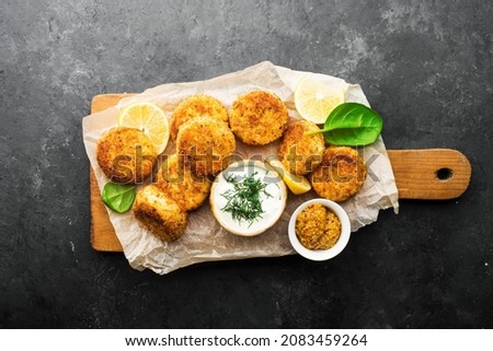 Fish cod potato cakes. Fish fritters with sauces and lemon wedges. Top view