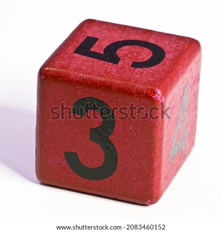 Number three and five written on a red wooden cube of a calendar date.
