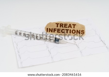 On the table is a cardiogram, a syringe and paper with the inscription - Treat Infections