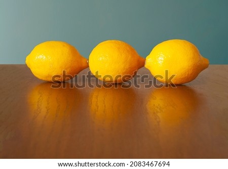 Vivid yellow lemons on a wooden table. Royalty-Free Stock Photo #2083467694