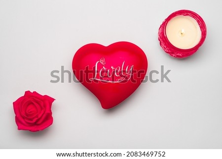 creative picture using a heart shape, candle and flower.
