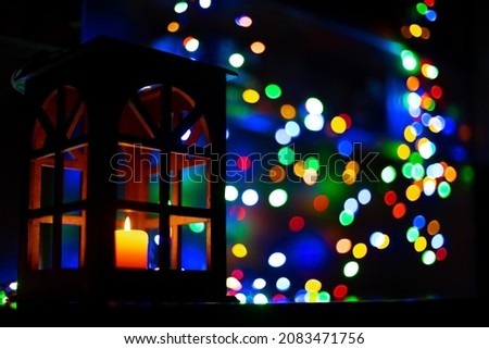 unfocused concept festive mood picture of holy Christmas time indoor decorative and festive atmosphere of yellow candle light glowing with garland fuzzy bokeh colorful effects on background