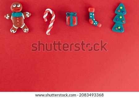 plasticine homemade figures, symbols of Christmas and New Year on a red background