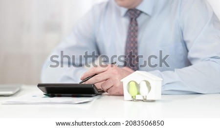 One man is working with documents at the table. High quality photo