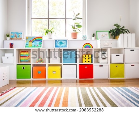 White nursery room with shelves and colourful boxes. Royalty-Free Stock Photo #2083552288