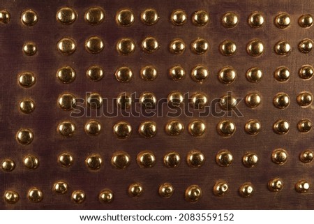 Brown wood background with metal gold buttons, high resolution.