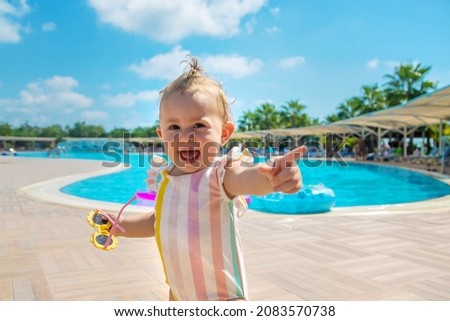 Child in sunglasses by the pool. Selective focus. Travel.