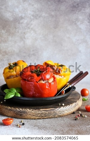 Stuffed pepper. Paprika with rice and minced meat. Baked peppers in a cast iron pan on a concrete background. Dinner Royalty-Free Stock Photo #2083574065