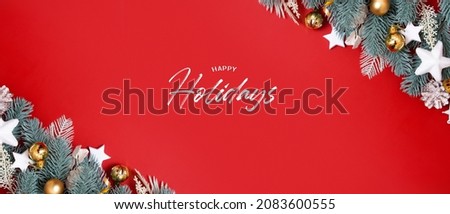Banner with flat lay christmas decorations and Happy Holidays greeting text on red background  
