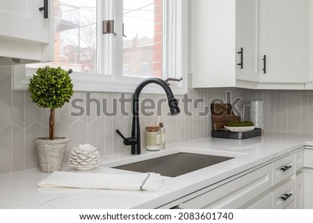 Modern White Kitchen Sink with White Counters Royalty-Free Stock Photo #2083601740